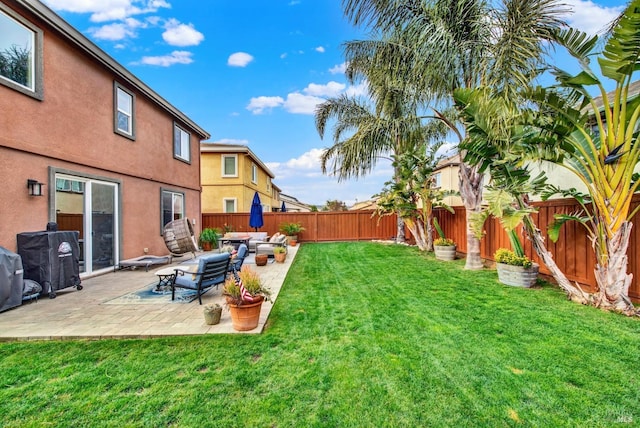 view of yard featuring a fenced backyard, a patio, and an outdoor hangout area