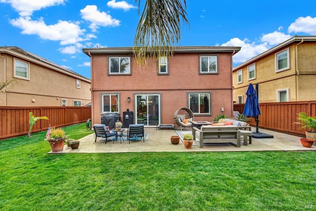 back of property with a lawn, an outdoor living space with a fire pit, and a fenced backyard