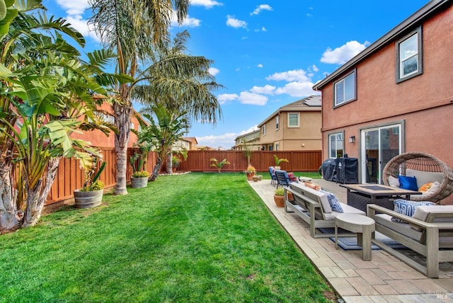 view of yard with an outdoor living space with a fire pit, a patio, and a fenced backyard