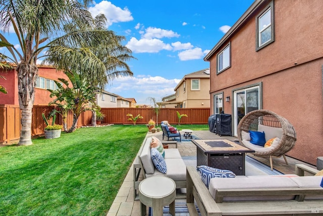 view of patio / terrace with a fenced backyard and an outdoor living space with a fire pit