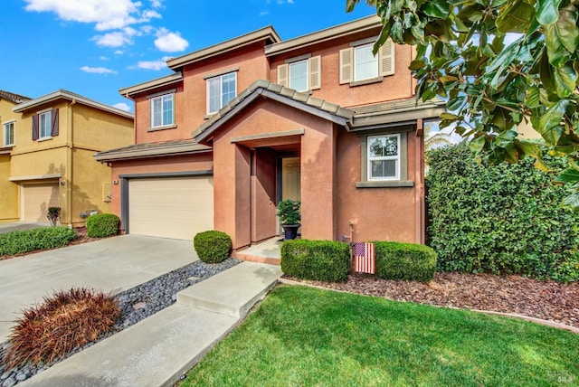 view of front of property featuring an attached garage, concrete driveway, and stucco siding