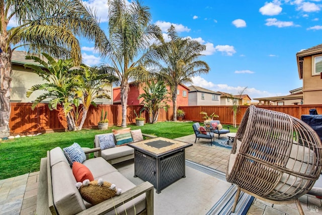 view of patio with a residential view, an outdoor living space with a fire pit, and a fenced backyard