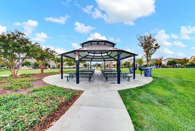 surrounding community with a gazebo and a yard