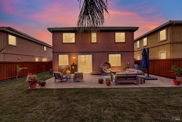 rear view of property featuring a fenced backyard, outdoor lounge area, and a yard