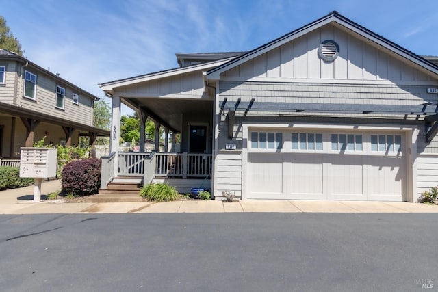 view of front of house featuring driveway, covered porch, and an attached garage