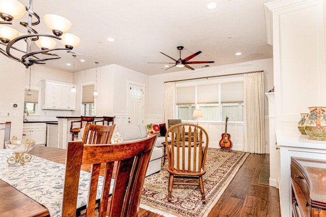 dining area with recessed lighting, ceiling fan with notable chandelier, and dark wood-type flooring