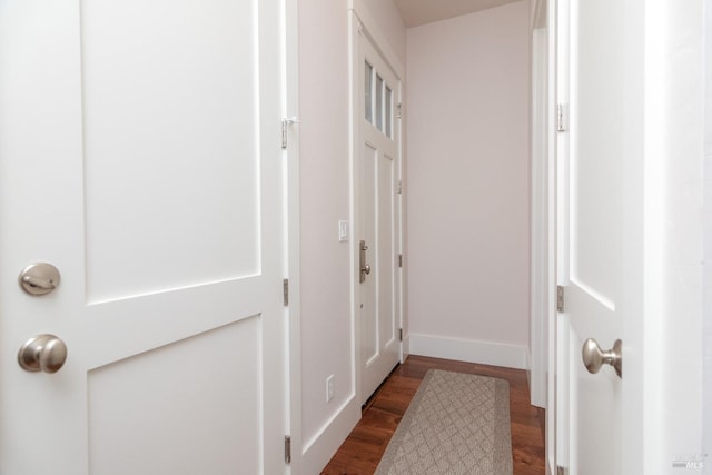 hall with dark wood-style floors and baseboards