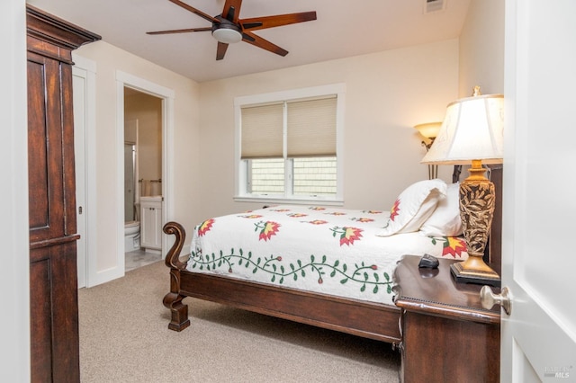 bedroom with a ceiling fan, visible vents, carpet floors, and connected bathroom