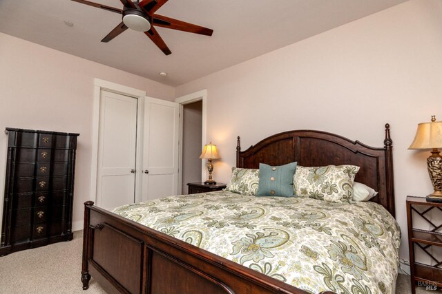 bedroom with light colored carpet and ceiling fan