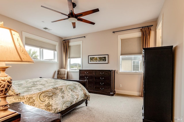 bedroom with visible vents, baseboards, a ceiling fan, and carpet flooring