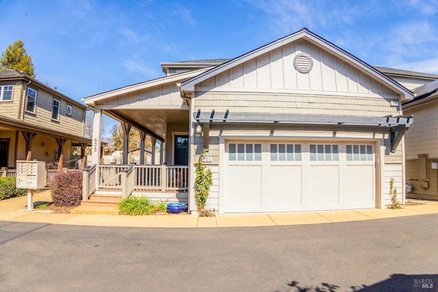 view of front facade with covered porch, board and batten siding, and a garage