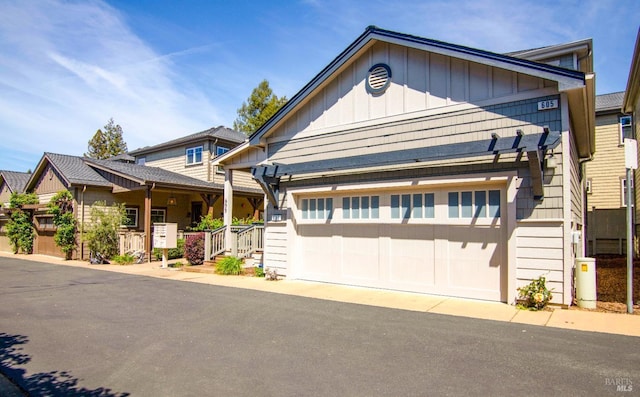 view of front facade with a garage, a residential view, and board and batten siding