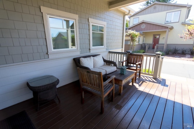 wooden terrace with an outdoor hangout area