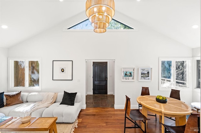 living area featuring baseboards, a chandelier, wood finished floors, and recessed lighting