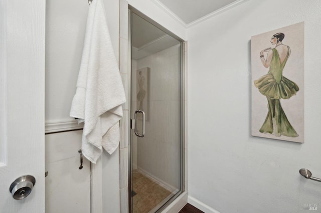 full bath with a stall shower and crown molding