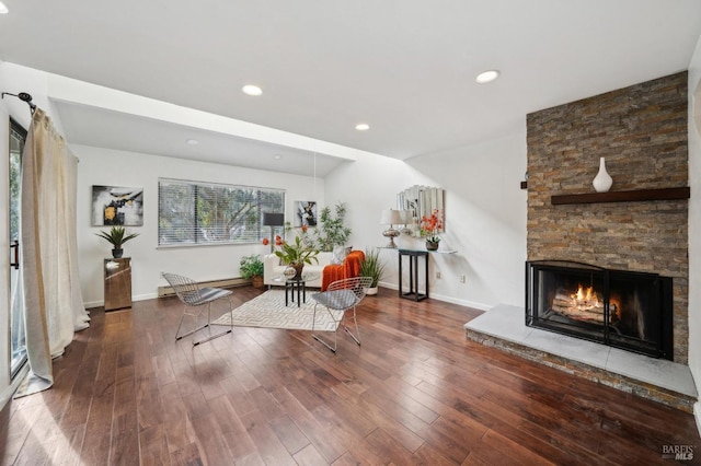 unfurnished living room with a fireplace, baseboards, wood finished floors, and recessed lighting