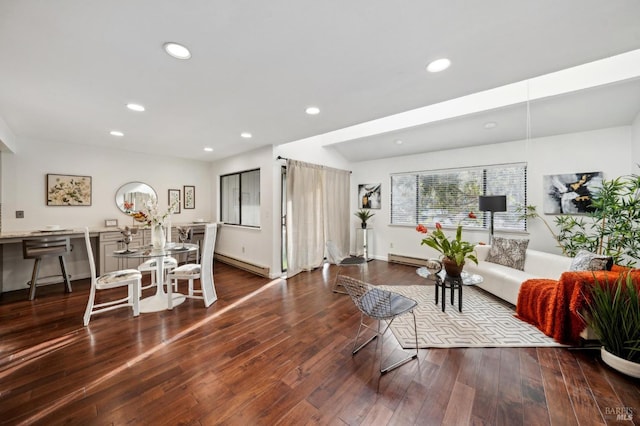 living area with a baseboard heating unit, recessed lighting, baseboards, and wood finished floors