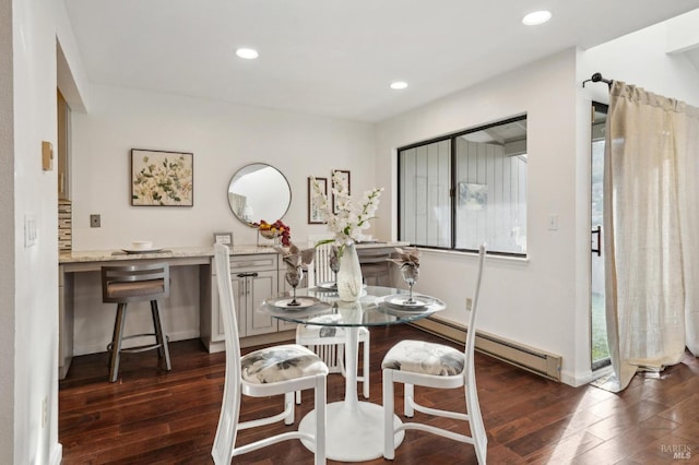 dining area featuring a baseboard heating unit, dark wood-type flooring, and recessed lighting