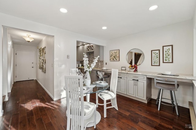 dining space featuring baseboards, dark wood-type flooring, and recessed lighting