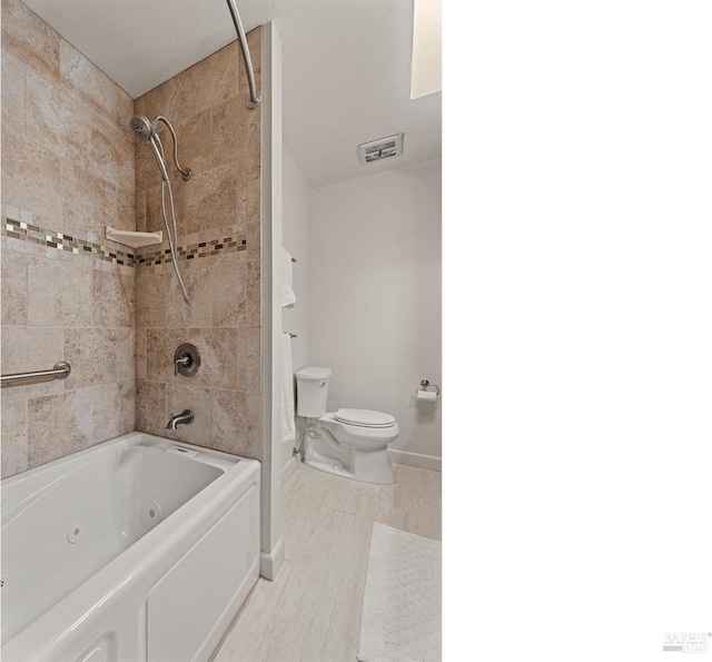 full bath featuring baseboards, visible vents, toilet, wood finished floors, and a combined bath / shower with jetted tub