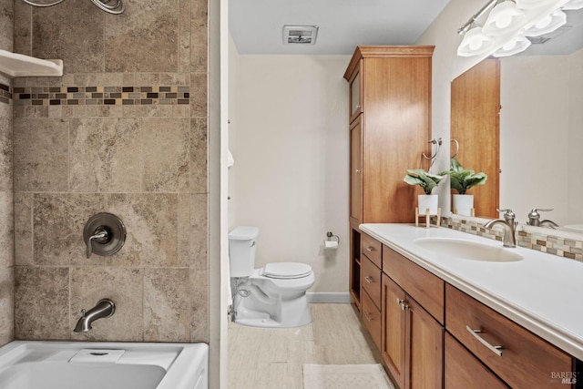 full bath with toilet, wood finished floors, vanity, baseboards, and  shower combination