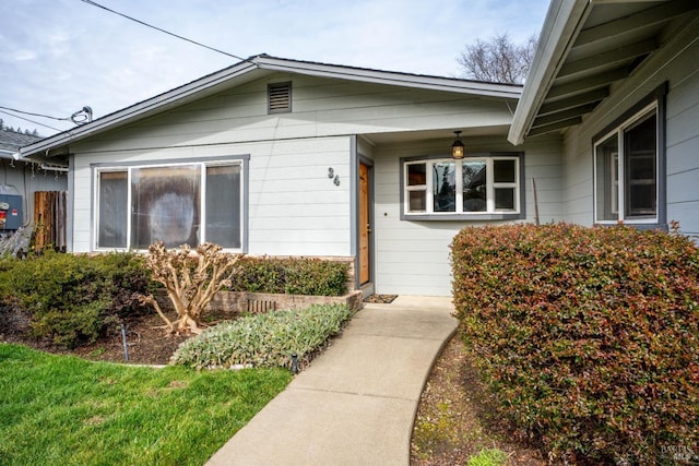 property entrance with a yard