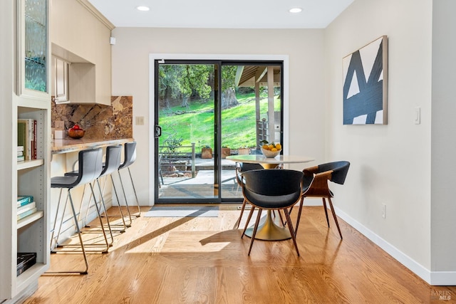 dining area featuring light wood-type flooring, recessed lighting, and baseboards