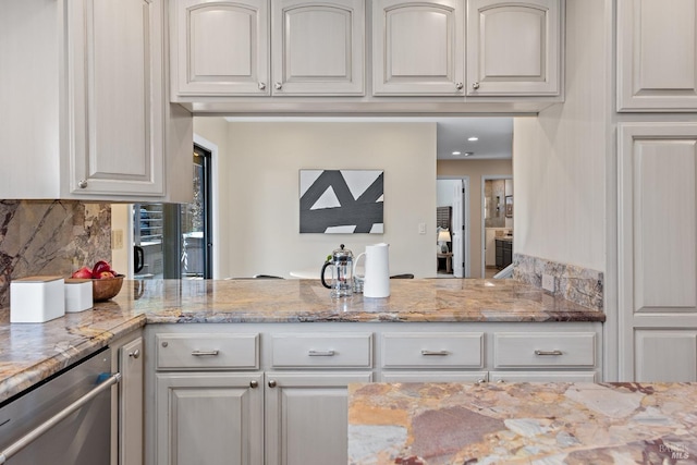 kitchen featuring light stone counters, a peninsula, white cabinetry, backsplash, and dishwasher