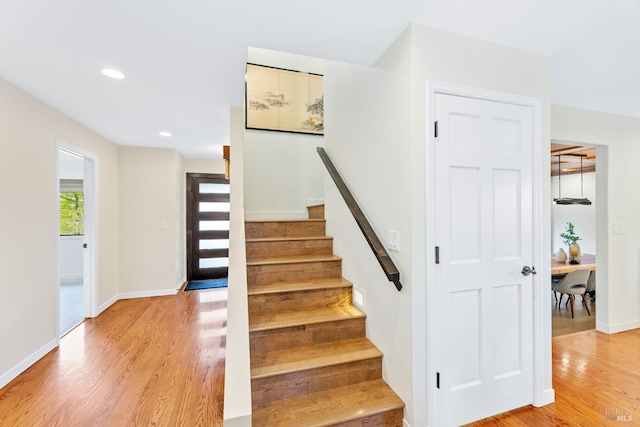 stairs featuring recessed lighting, baseboards, and wood finished floors