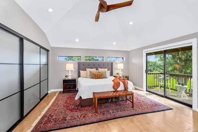 bedroom featuring access to exterior, multiple windows, and vaulted ceiling