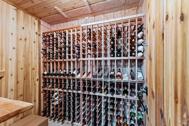 wine room with wood walls and wood ceiling