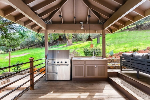 exterior space featuring a sink, a grill, a deck, and a gazebo