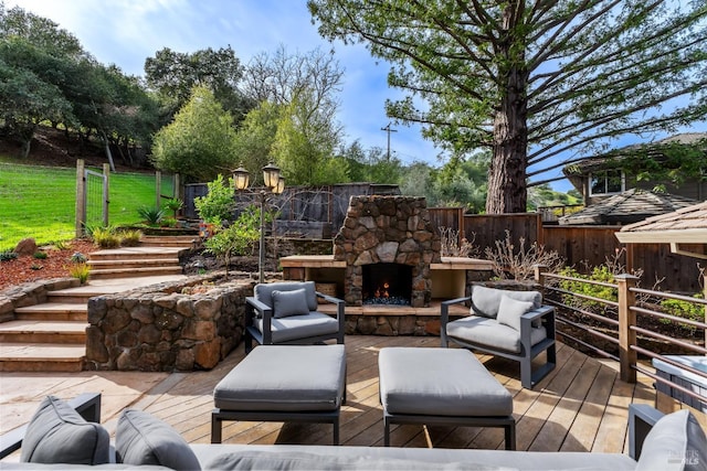 wooden deck with fence and an outdoor living space with a fireplace