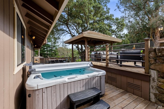 wooden terrace with a hot tub