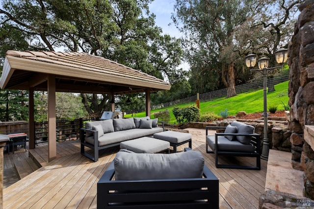 wooden deck featuring fence, an outdoor hangout area, and a gazebo