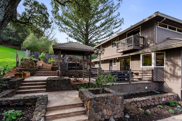 exterior space featuring a gazebo, crawl space, stairway, and a balcony