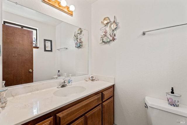 bathroom with toilet and vanity