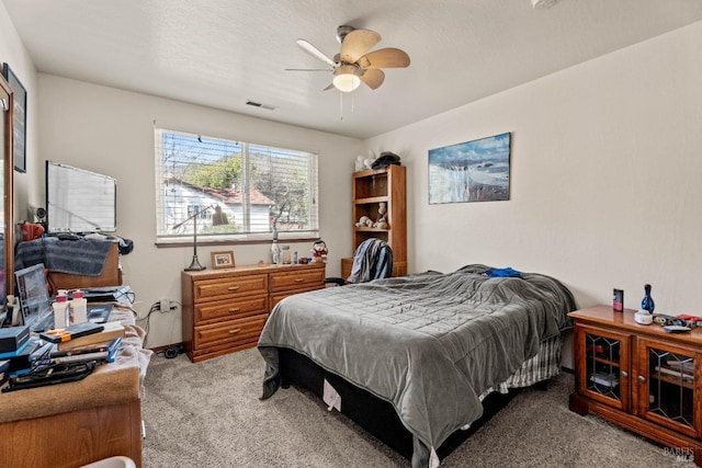 bedroom with carpet floors, ceiling fan, visible vents, and baseboards