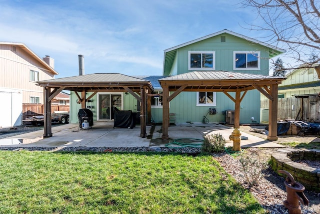 back of house featuring a lawn, a patio area, fence, and central air condition unit