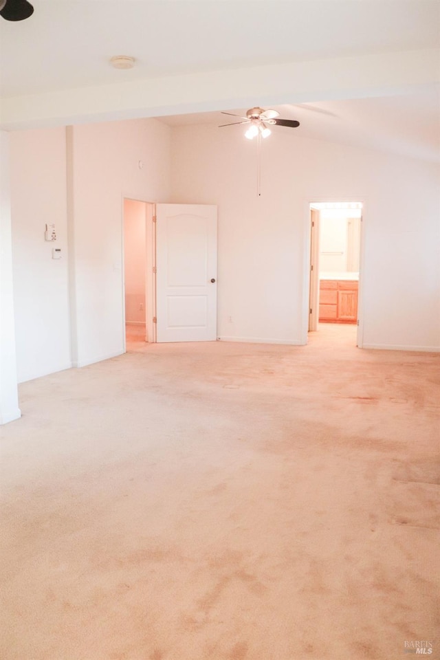 unfurnished room with vaulted ceiling, a ceiling fan, and light carpet