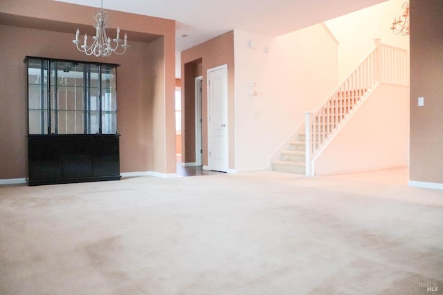 carpeted foyer entrance featuring stairway, baseboards, and a notable chandelier