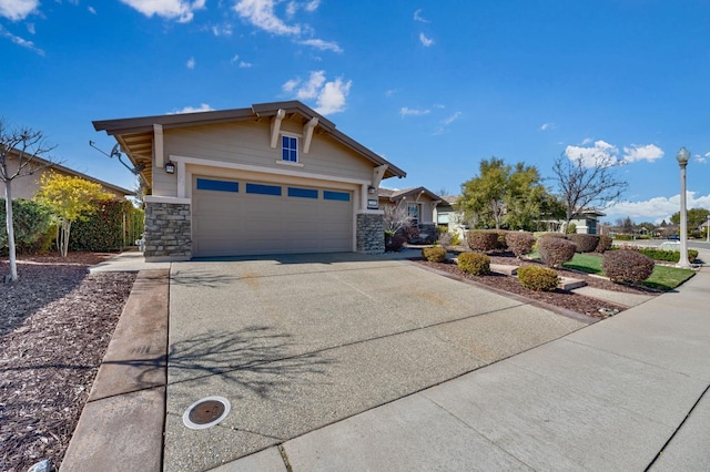 view of front facade featuring concrete driveway and stone siding