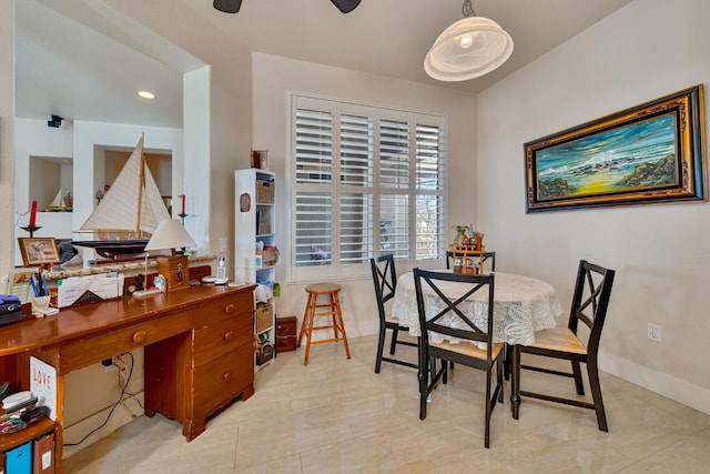 dining area with ceiling fan and baseboards