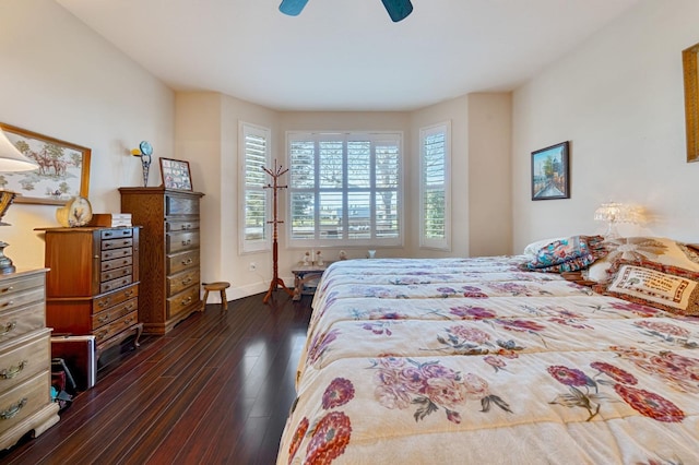 bedroom featuring baseboards, a ceiling fan, and dark wood-style flooring