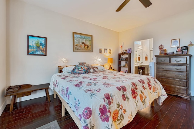 bedroom with dark wood-style floors, ensuite bath, baseboards, and a ceiling fan