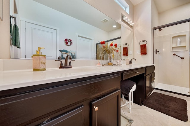 full bathroom with double vanity, tile patterned floors, a shower with door, and a sink