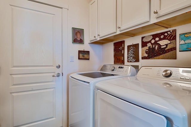 laundry area with cabinet space and washing machine and dryer