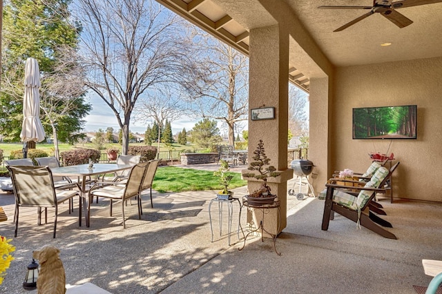 view of patio featuring outdoor dining area, a ceiling fan, and grilling area