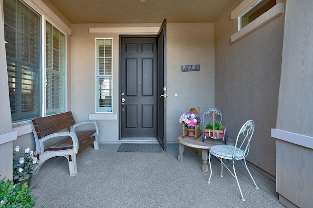 property entrance featuring stucco siding