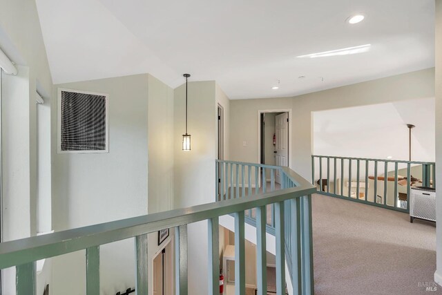 corridor featuring an upstairs landing, carpet, visible vents, and recessed lighting